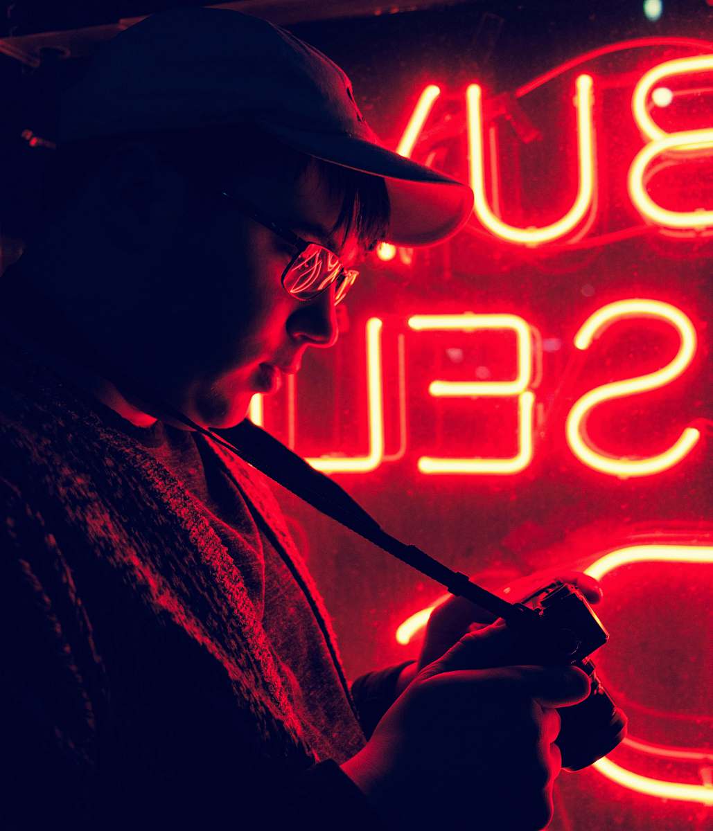 neon man standing in front of neon signage light