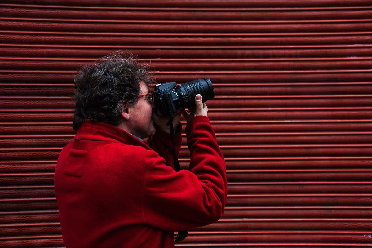 person man using black DSLR camera shoreditch