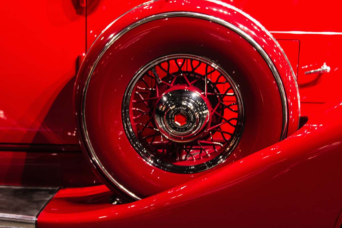 tire photo of a red vehicle wheel and tire set wheel
