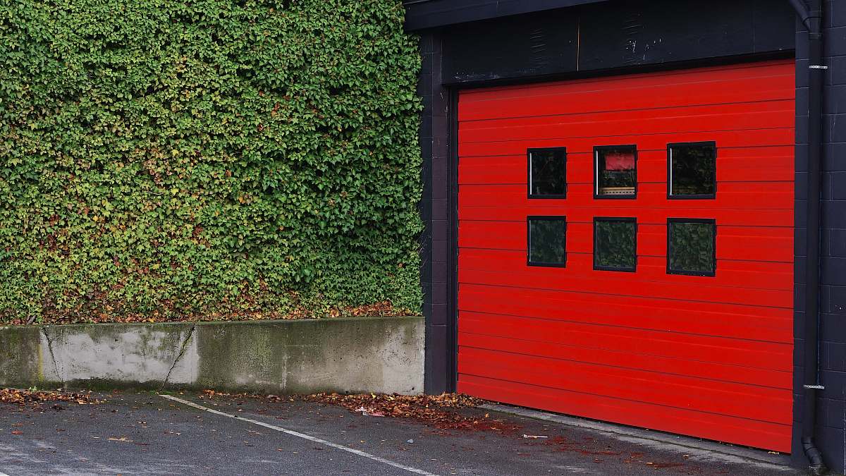 victoria red and black wooden shed beside grass canada