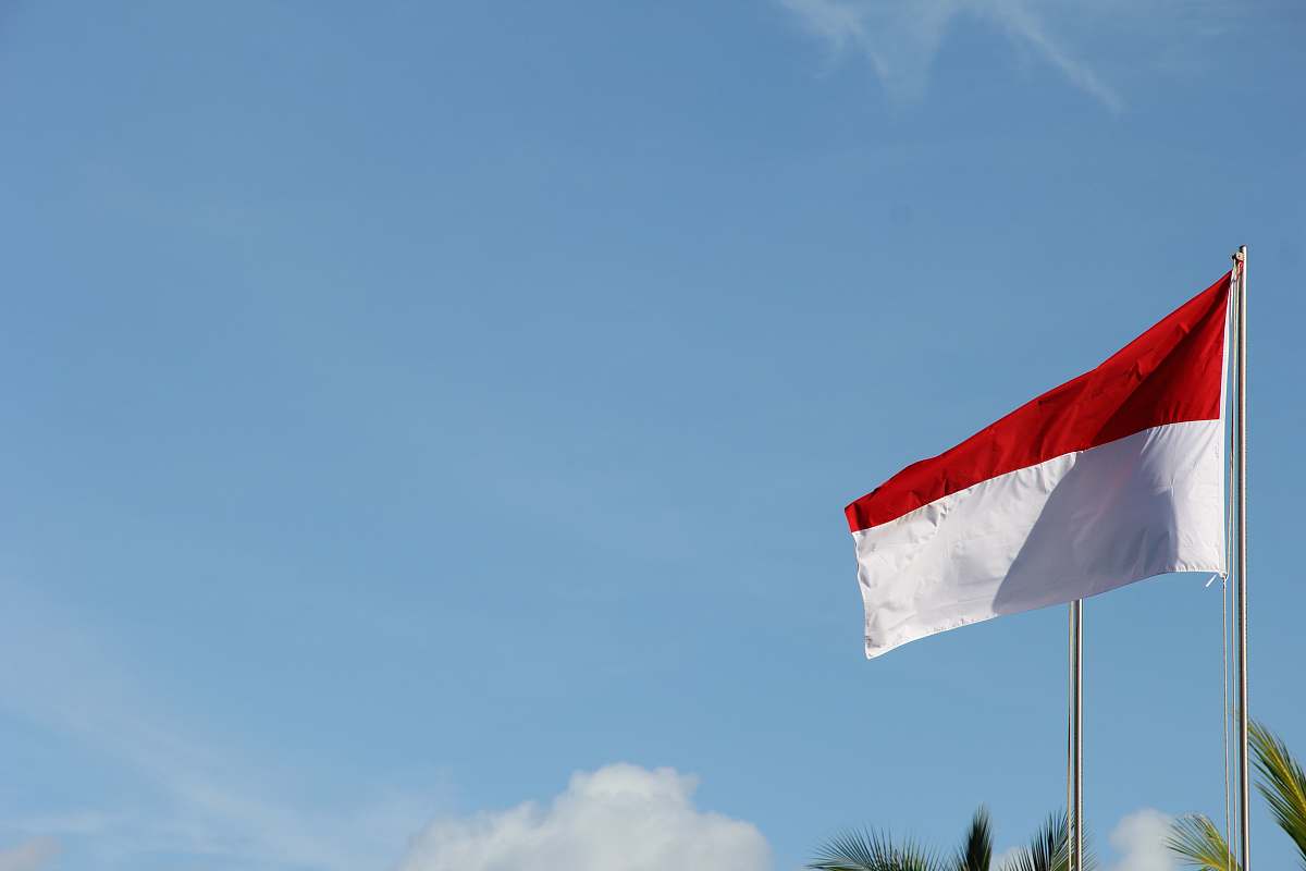 flag red and white flag under blue sky during daytime emblem