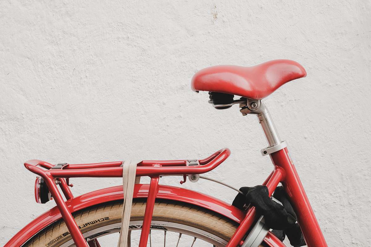 bike red bicycle near white wall bicycle