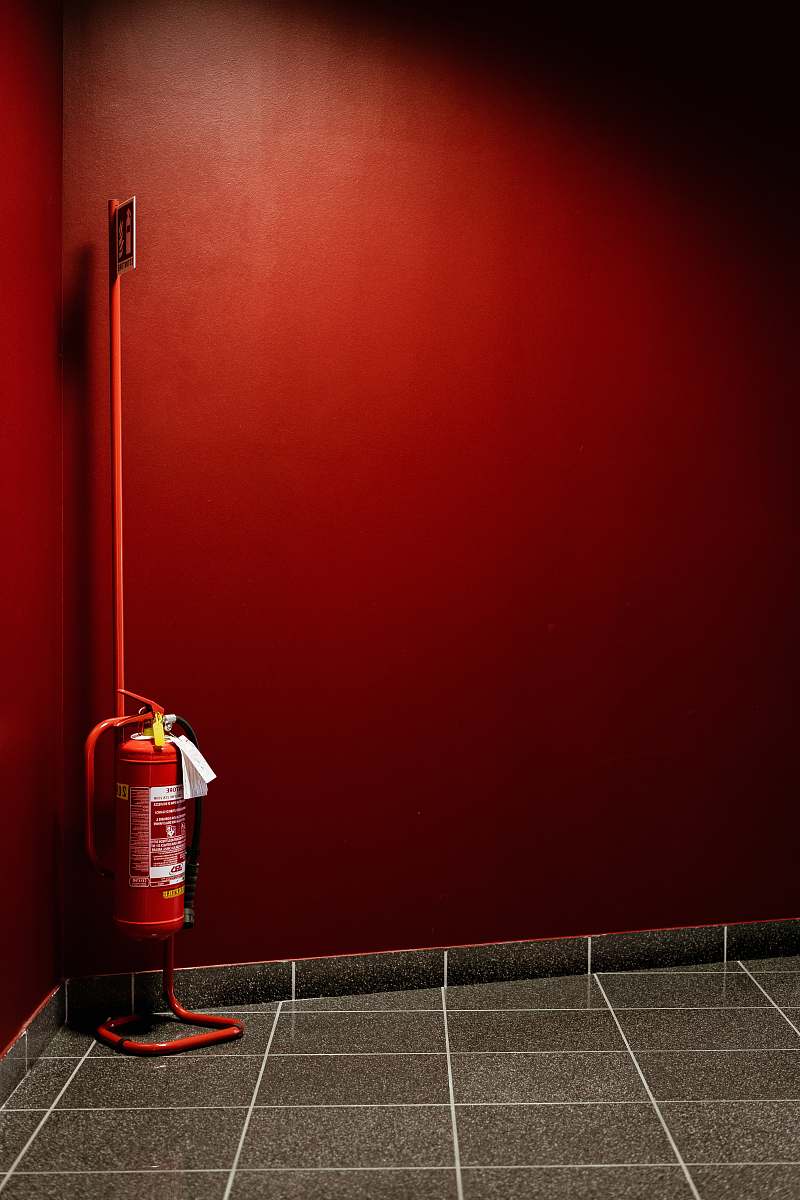fossano red fire extinguisher on corner italy
