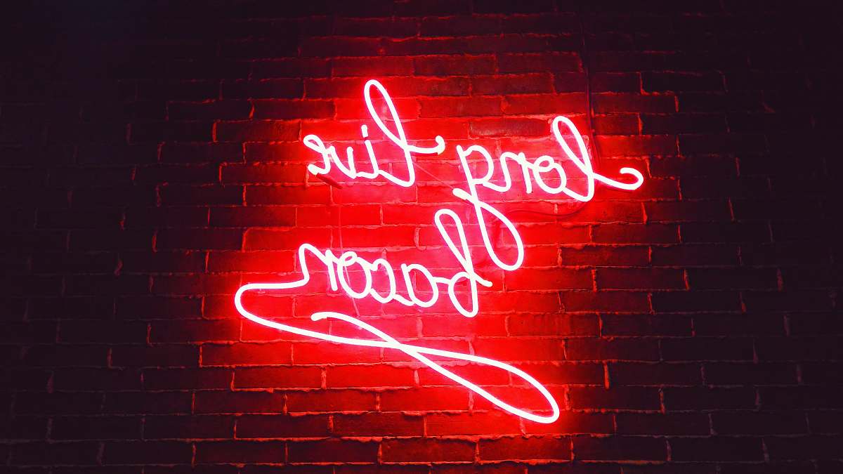 neon red ling live bacon neon light signage on brown wall bricks words