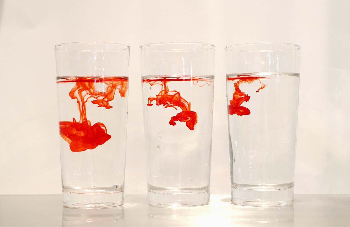 glass red powder in three clear drinking glasses goblet