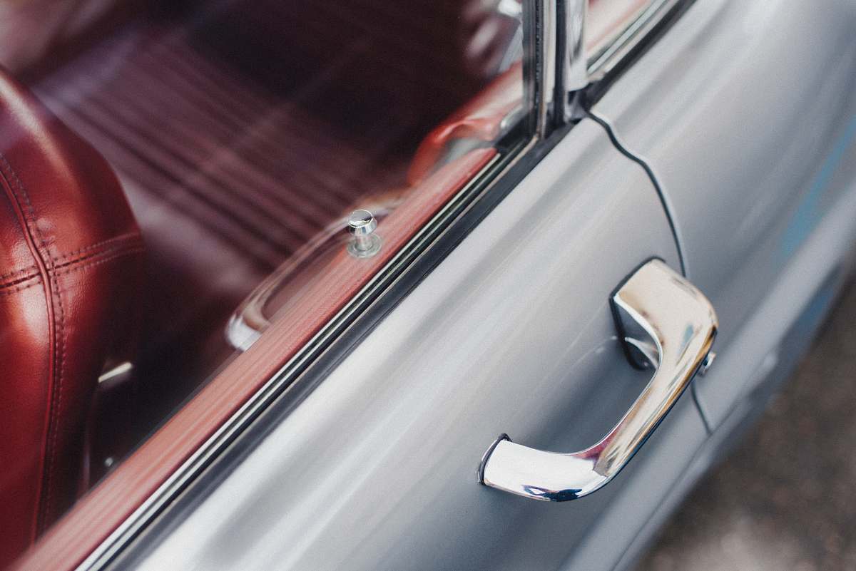 car selective focus photo of gray vehicle door handle oldschool