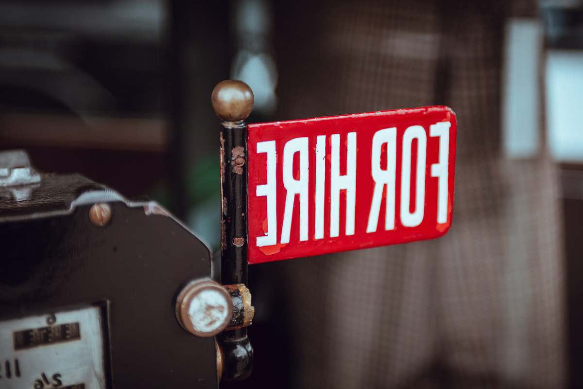 text shallow focus photography of red and white for hire signage sign