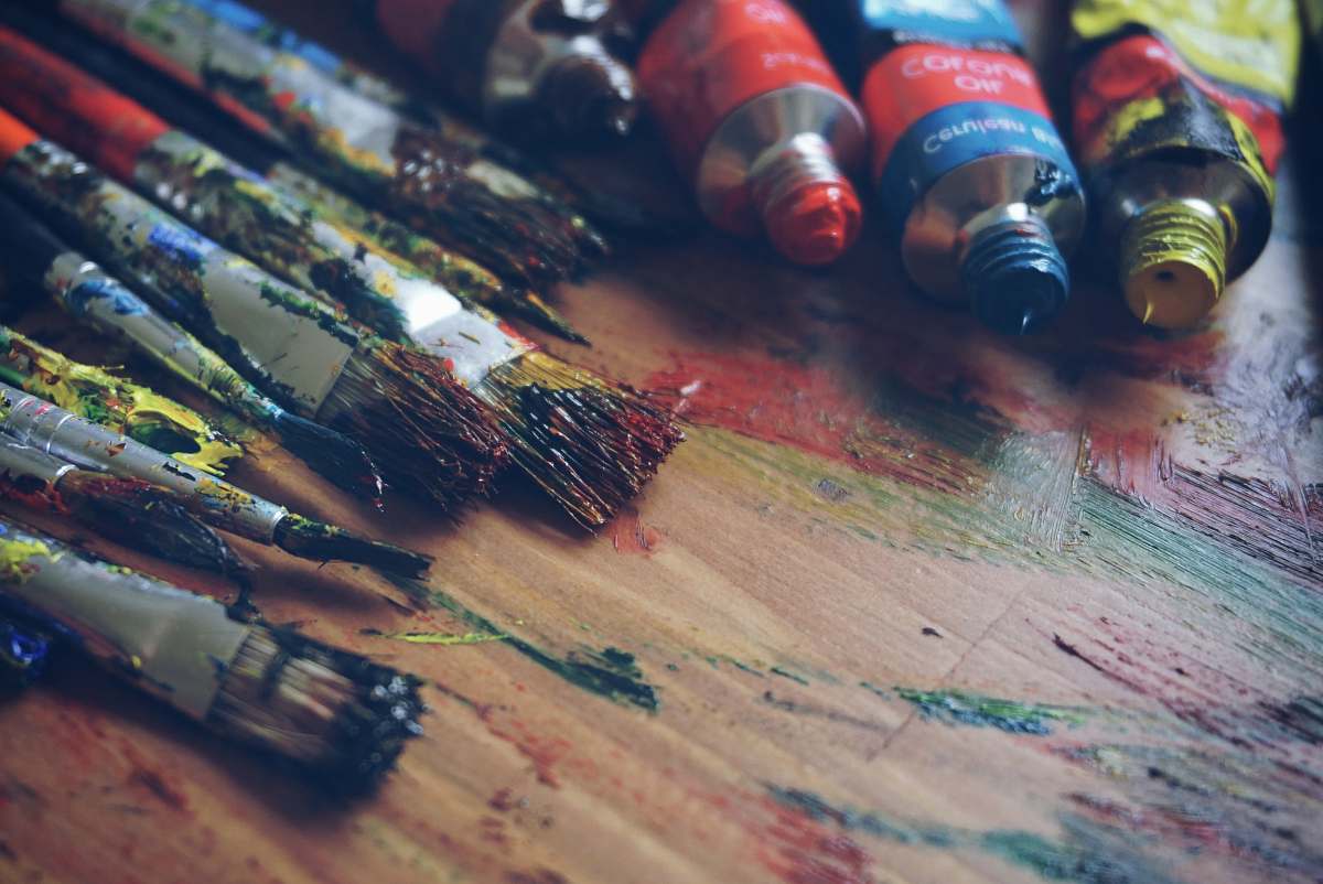 art three paint tubes near paint brushes brushes