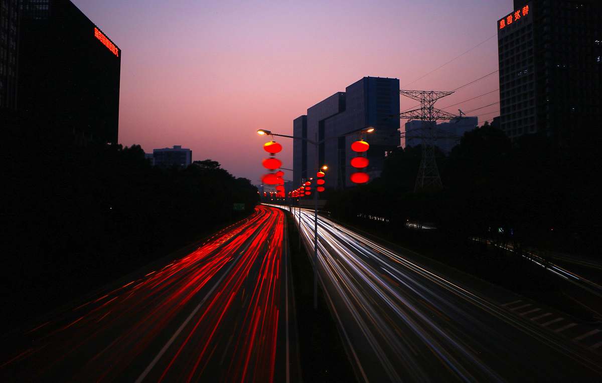 sunset timelapes photography of car lights on road during night time city