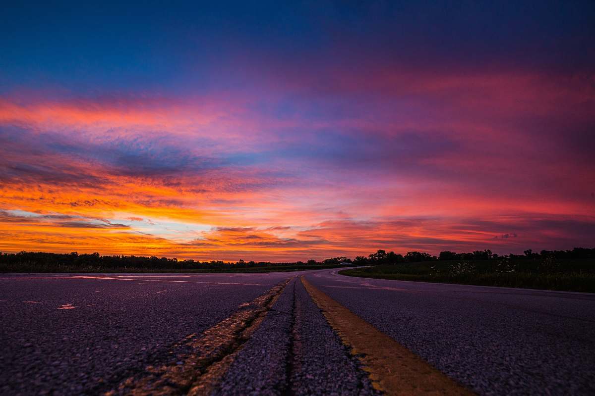 sunset road during sunset sunrise