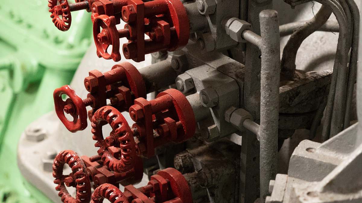 engine closeup photo of gray and red metal machine control