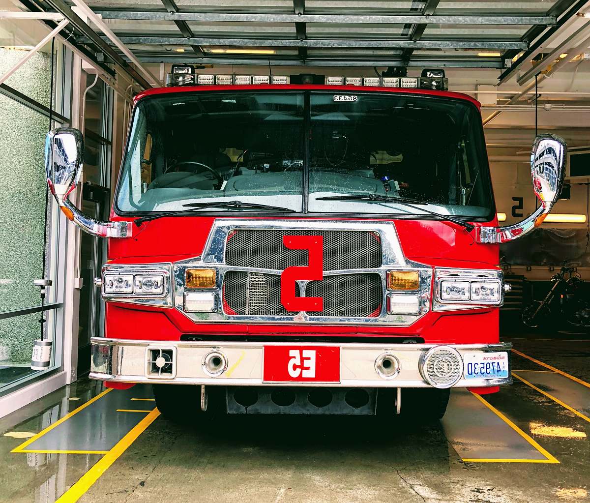 truck red and gray fire truck parked inside building fire truck