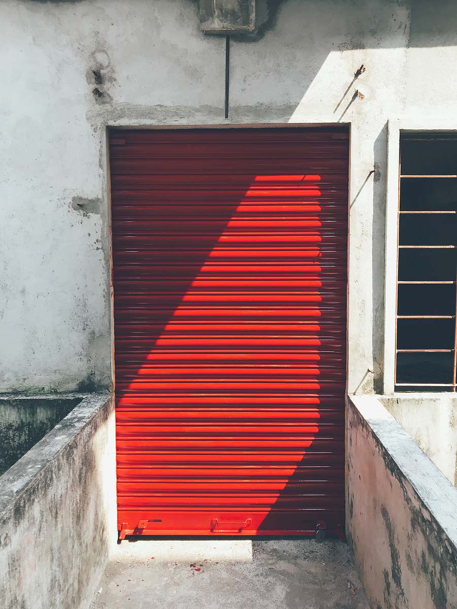 building closed red roller shutter entrance