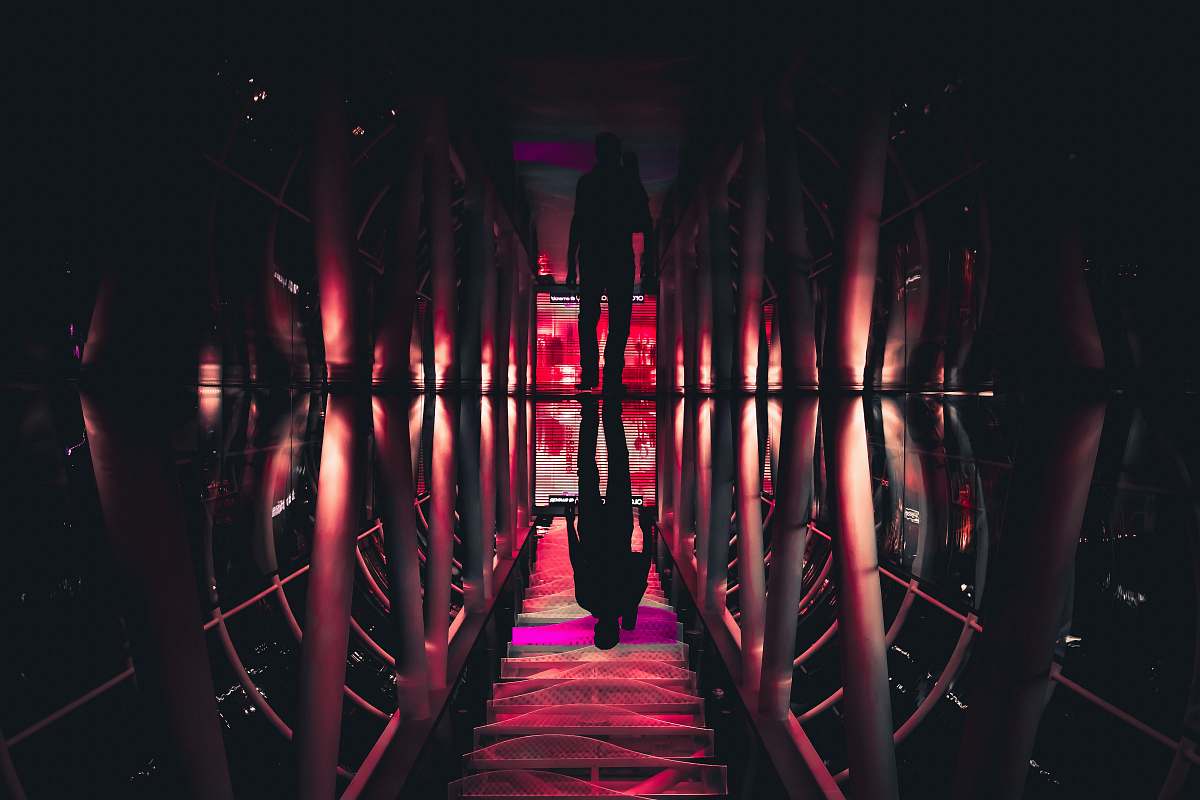 shadow man walking in pathway reflection