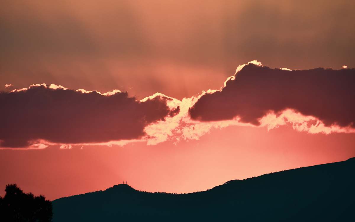 sunset silhouette photo of mountain during golden hour sunrise
