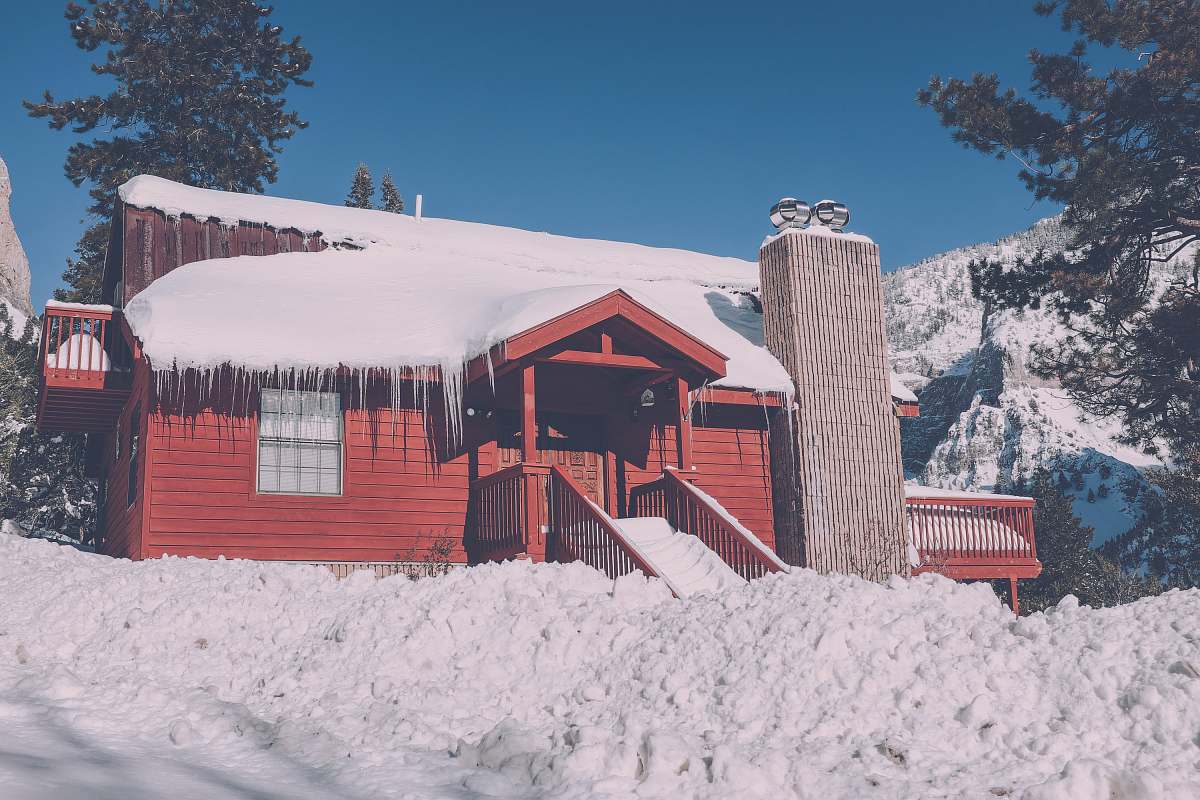 cabin snow capped red building house