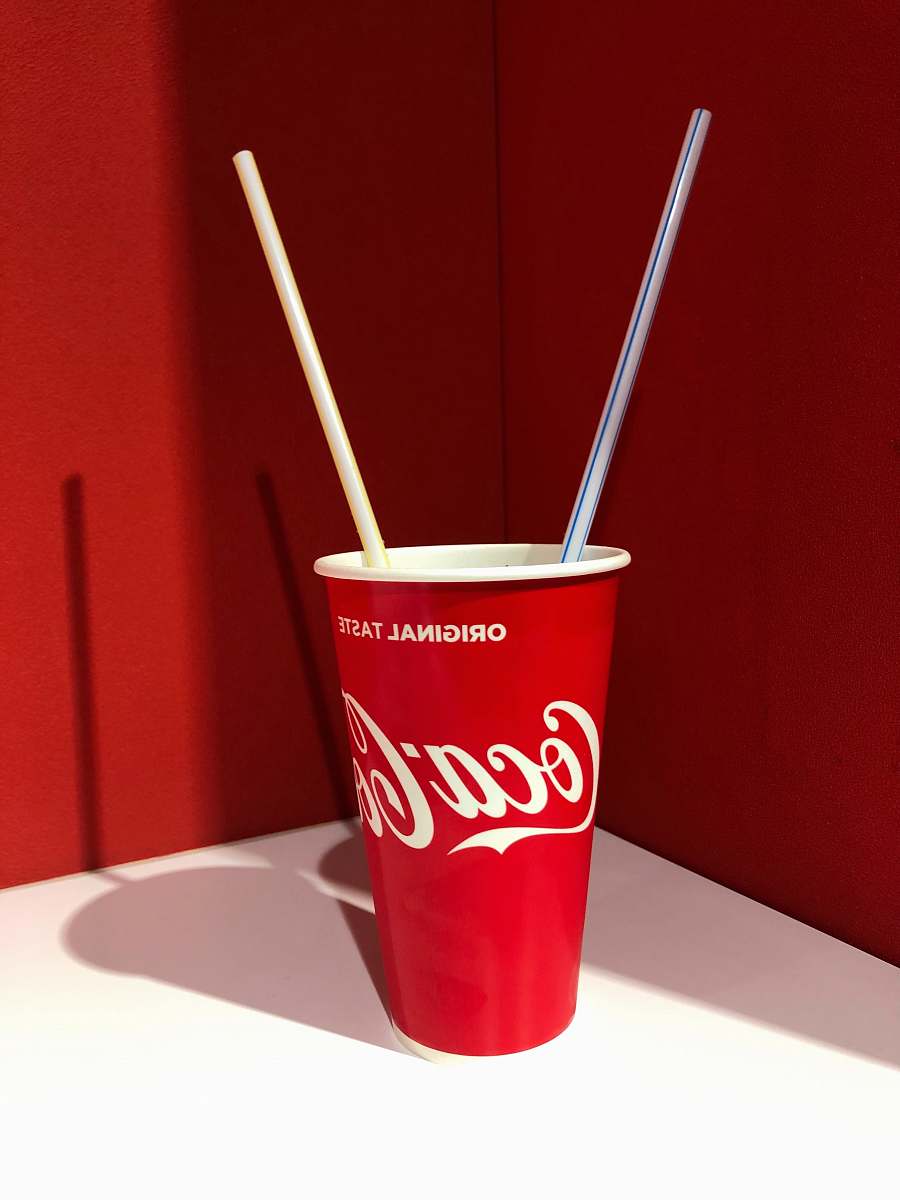 drink Coca-Cola disposable cup on top of white table coke