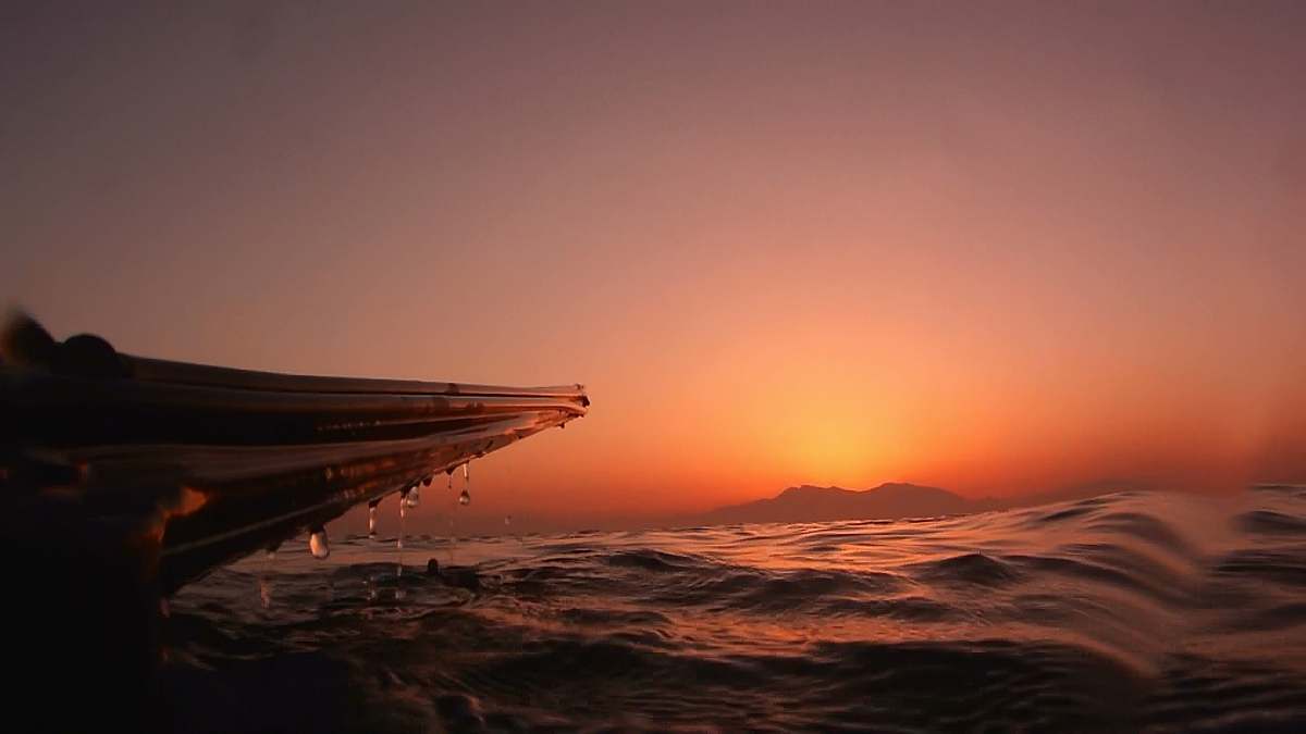 sunset silhouette of boat and water nature