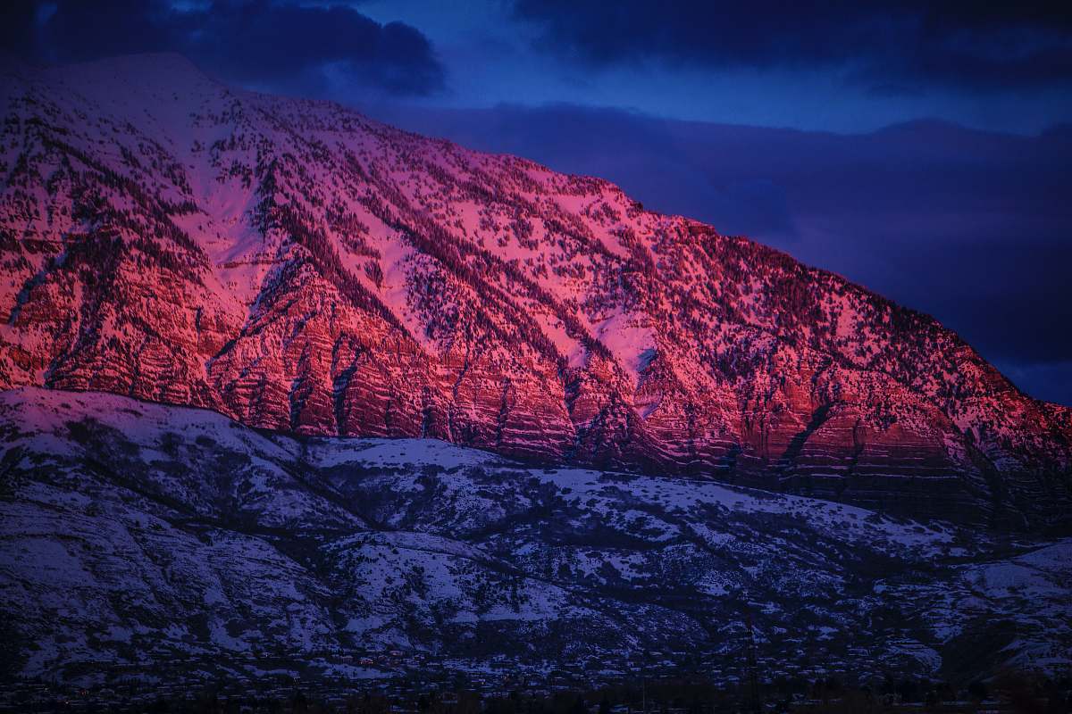 sunset snow-covered mountain under cloudy sky during nighttime mountains