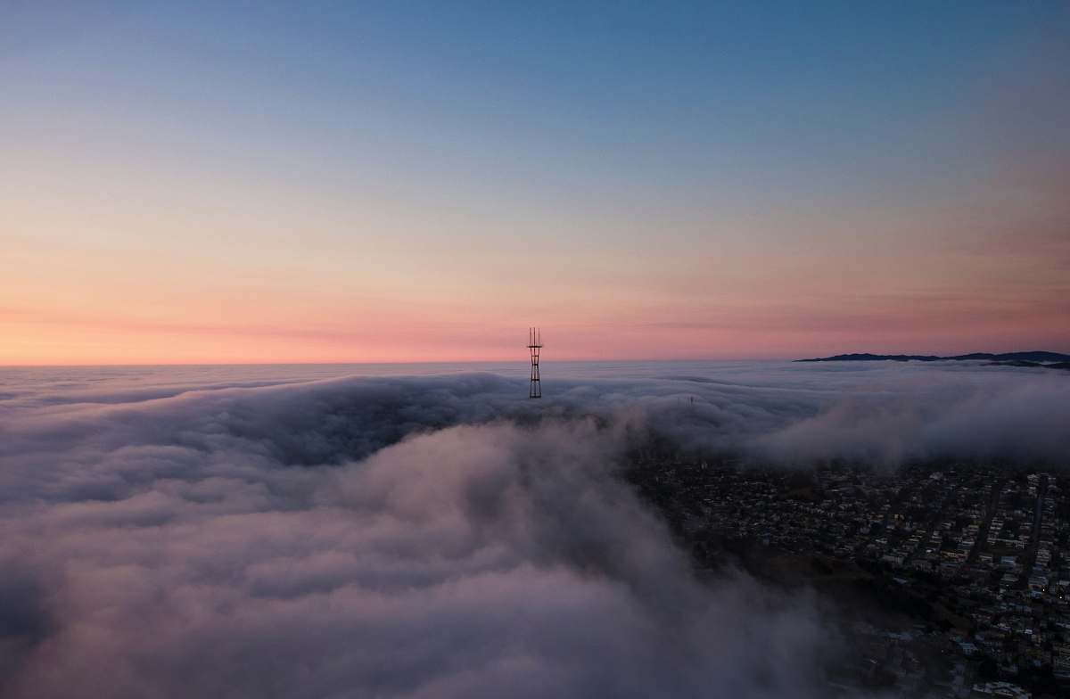 sunset tower surrounded by clouds san francisco