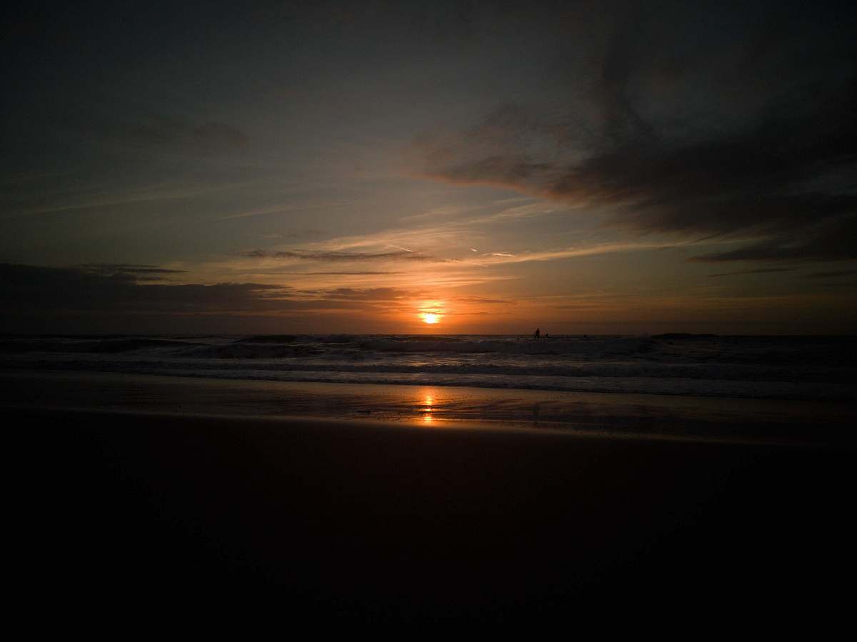 Experience the serene beauty of nature with this captivating sunset over a peaceful beach. The vibrant colors of the sky blend harmoniously with the calm waters, creating a breathtaking scene that invites relaxation and reflection. Perfect for travel blogs, lifestyle websites, or anyone looking to capture the essence of outdoor tranquility.