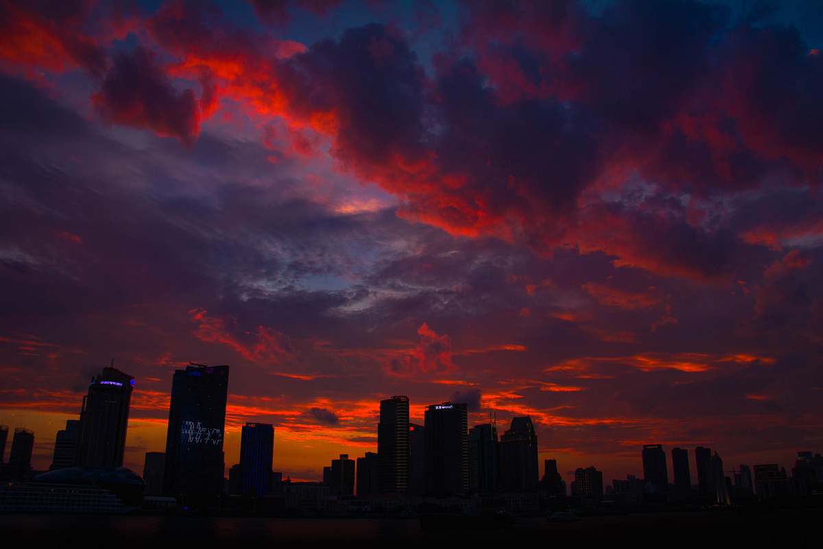 dawn silhouette of high rise buildings during golden hour sunrise
