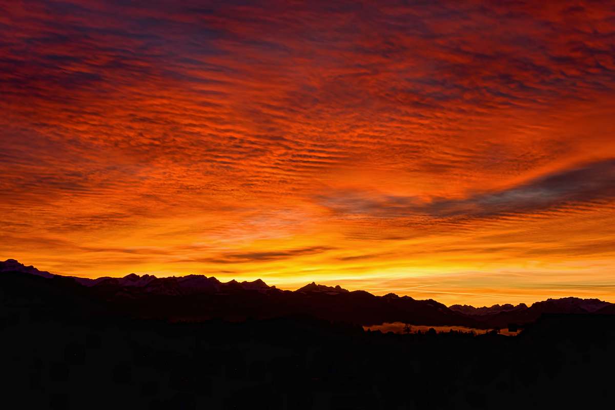 sky silhouette of mountains during golden hour sunrise