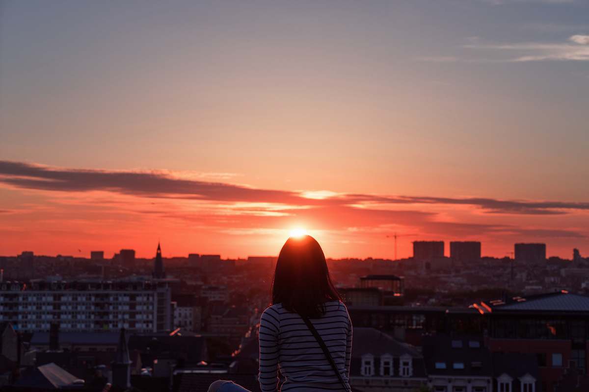 dawn woman standing in front of sunset dusk