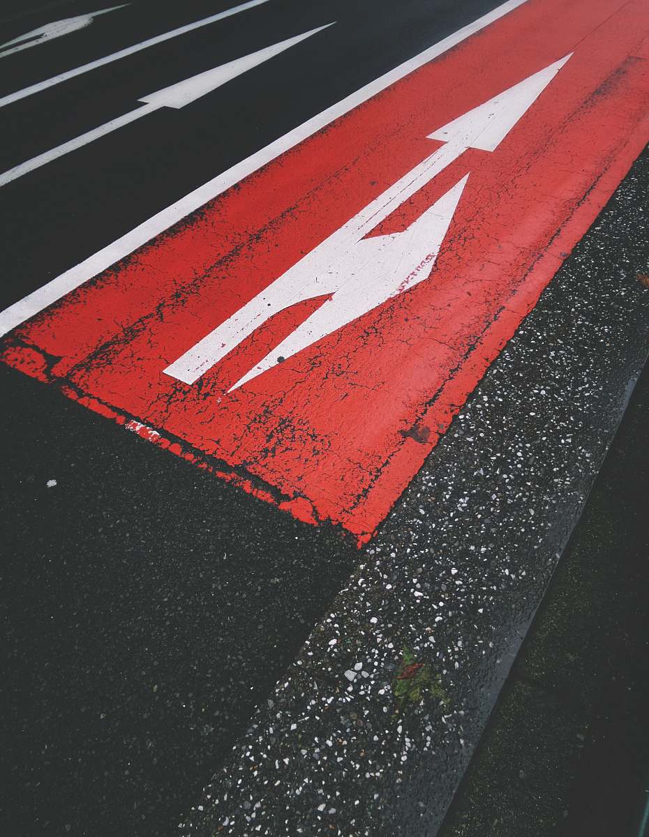 asphalt red and white road during daytime road