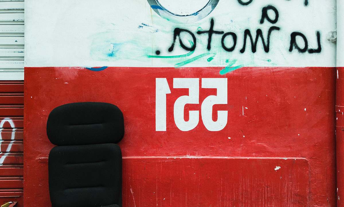 red 55` text signage cushion