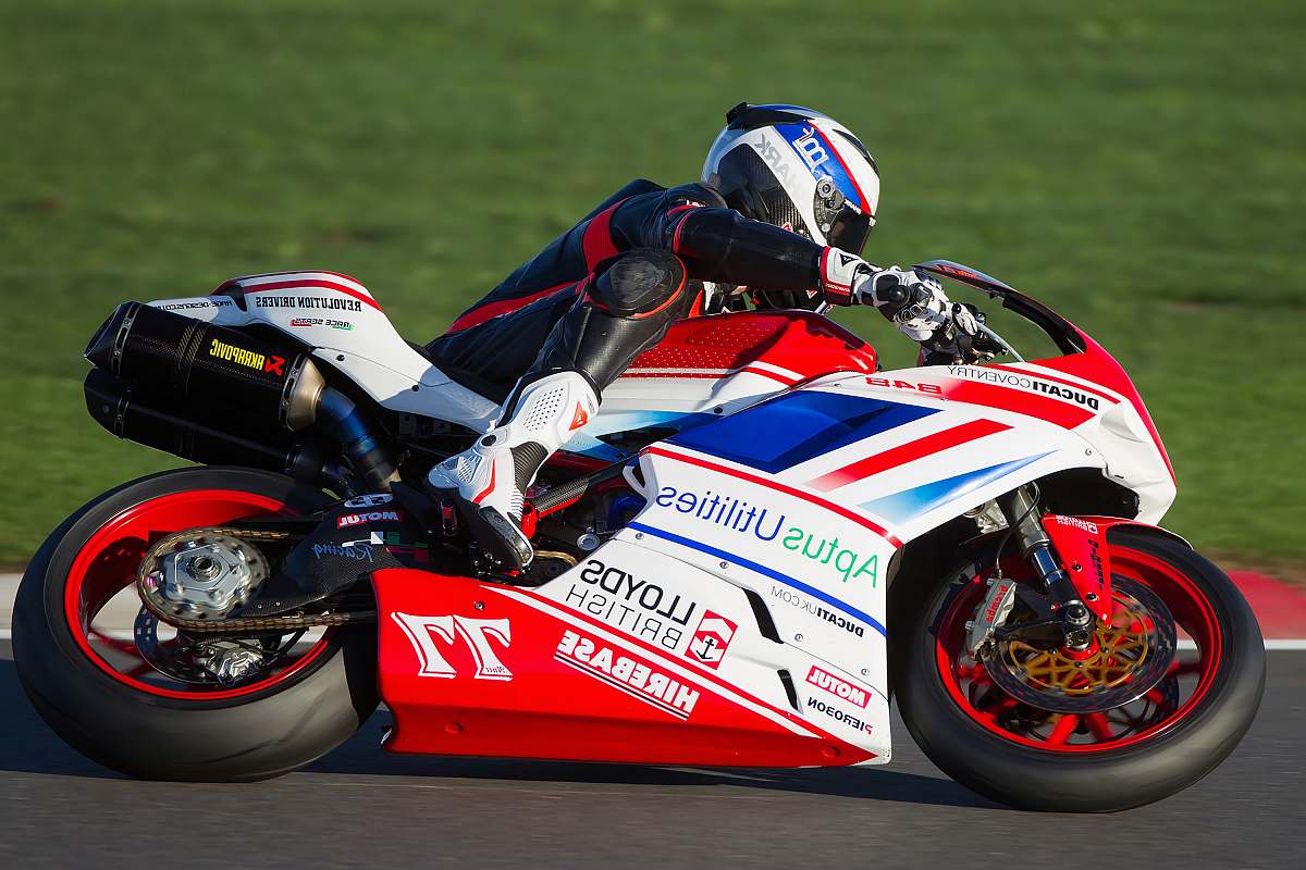 vehicle person riding red and white sportbike motorcycle
