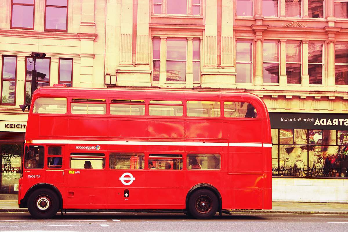 bus red double deck bus in front of building vehicle
