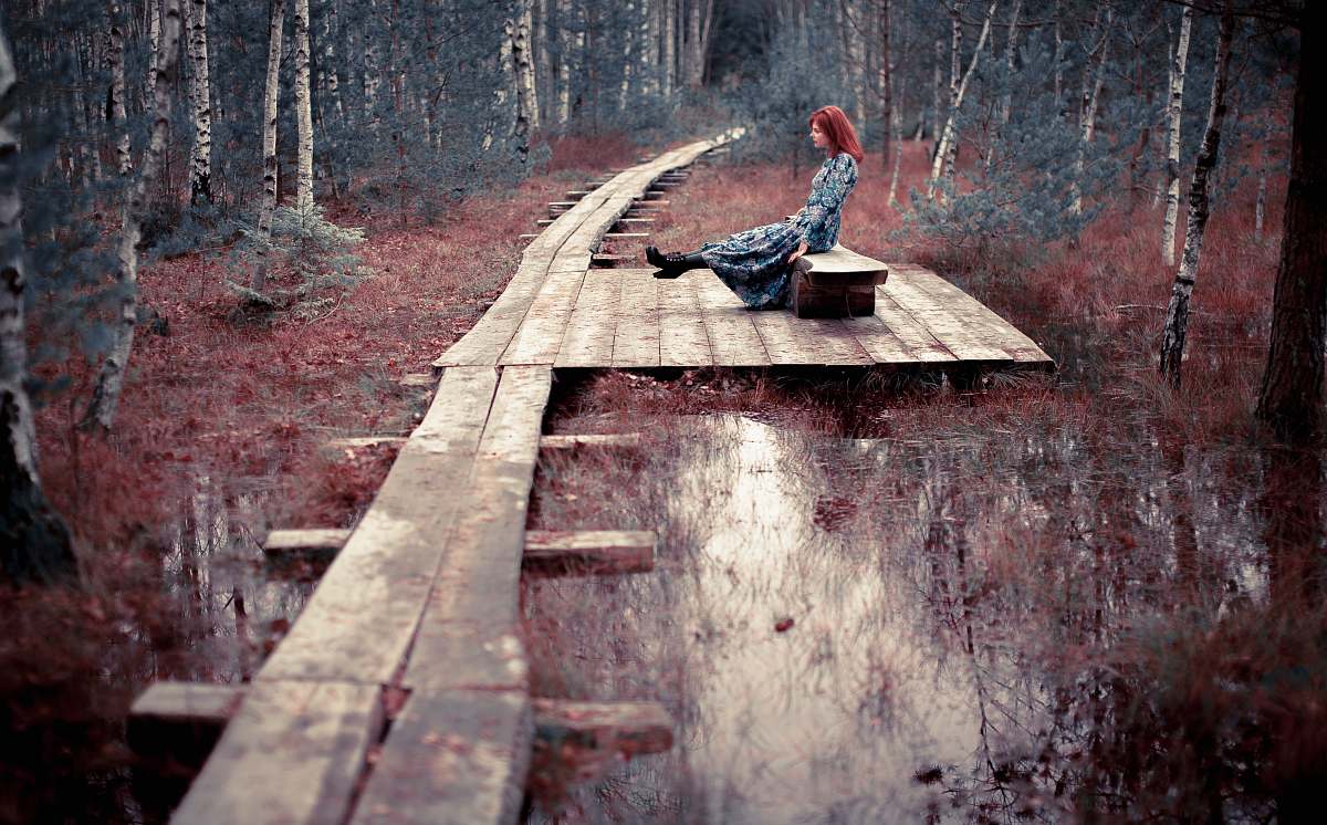 path woman seating on bench boardwalk