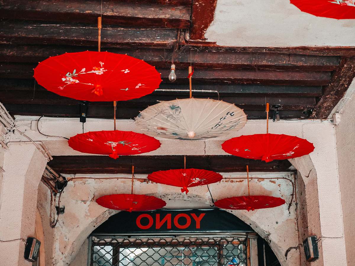 banister red and white opened umbrellas hanging on ceiling handrail