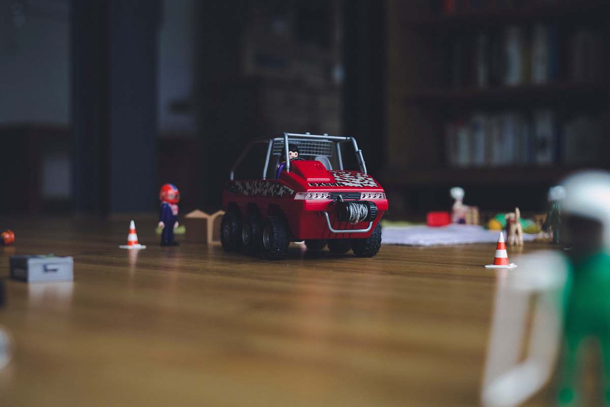 car red and black truck toy on floor automobile
