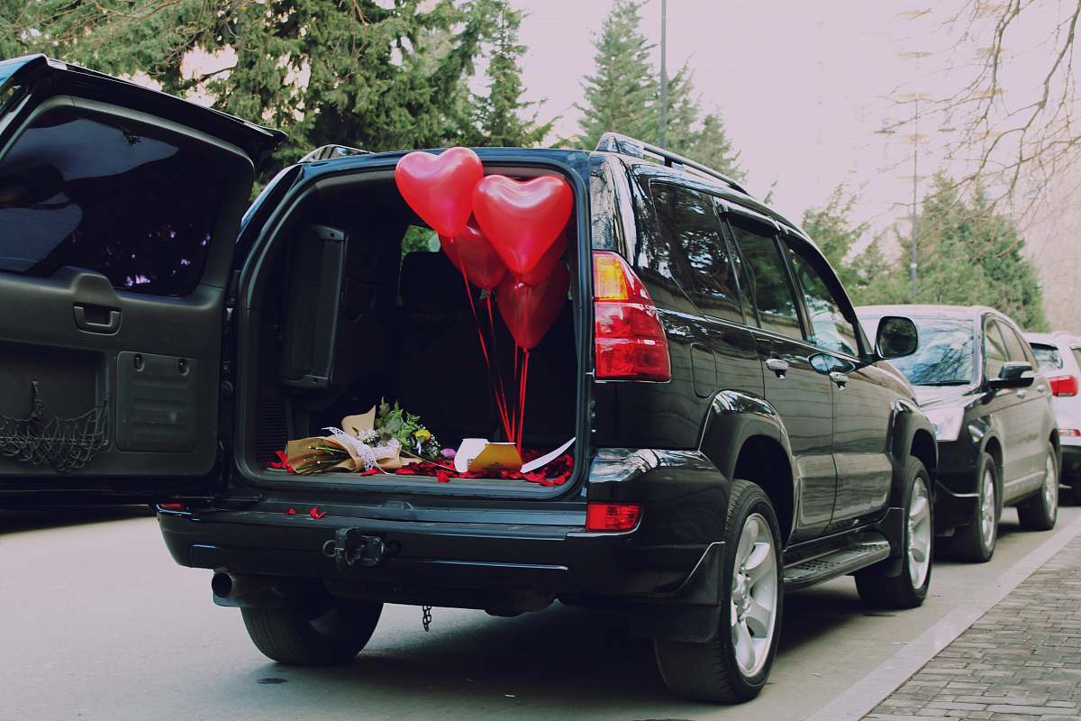 car red heart balloons inside car automobile