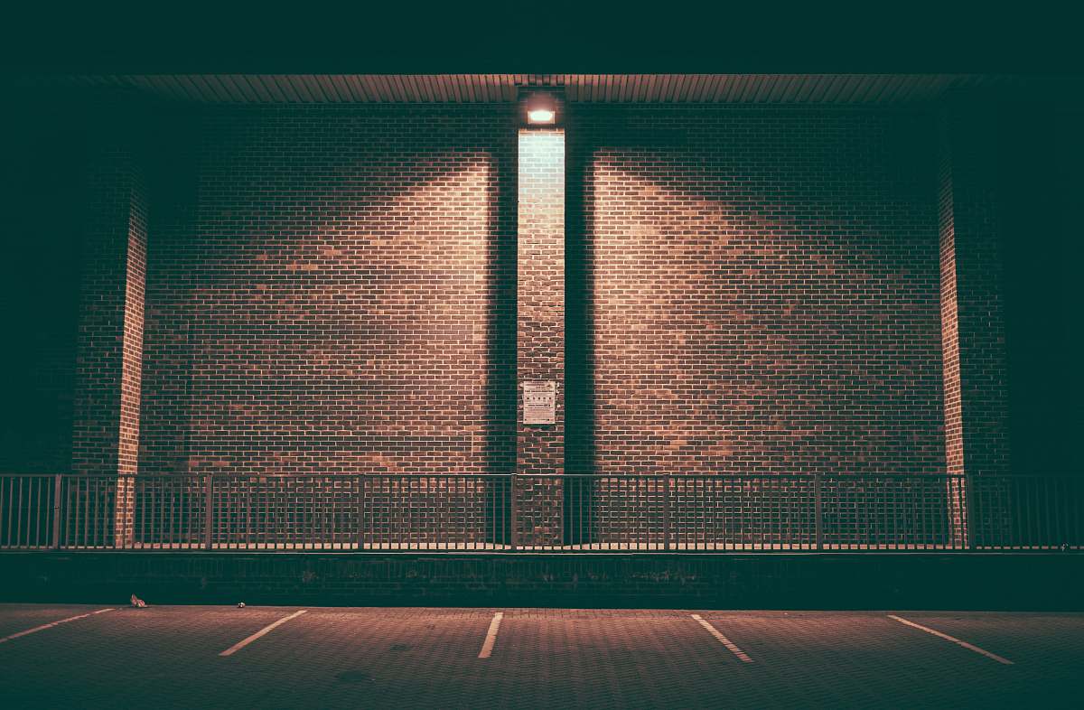 symmetrical brown concrete wall during daytime brown