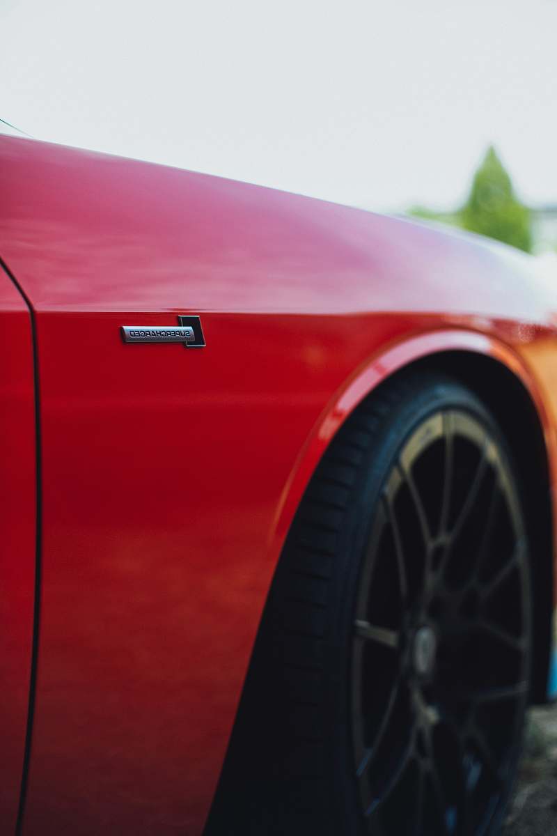 tire red vehicle in selective focus photography machine
