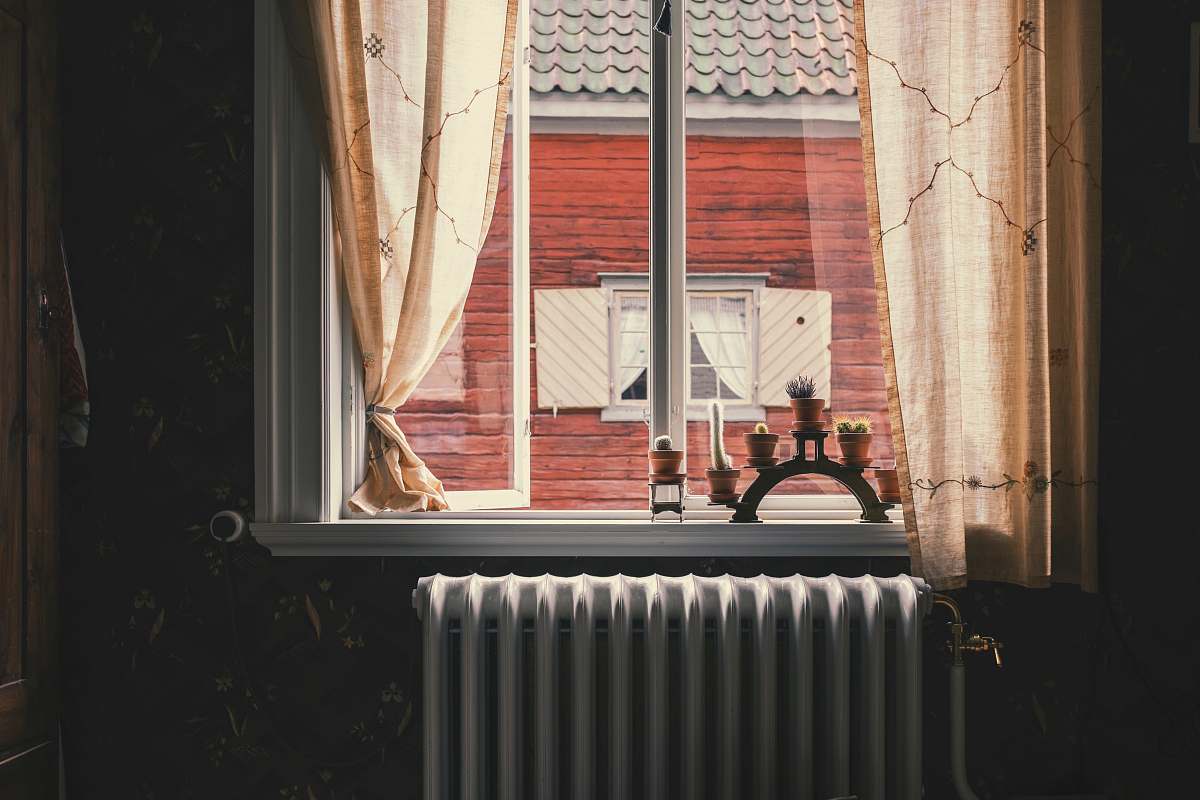 skansen kerosene heater by window during daytime svezia