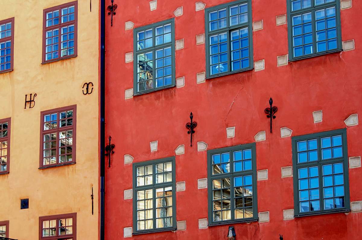 cross two red and brown concrete buildings emblem