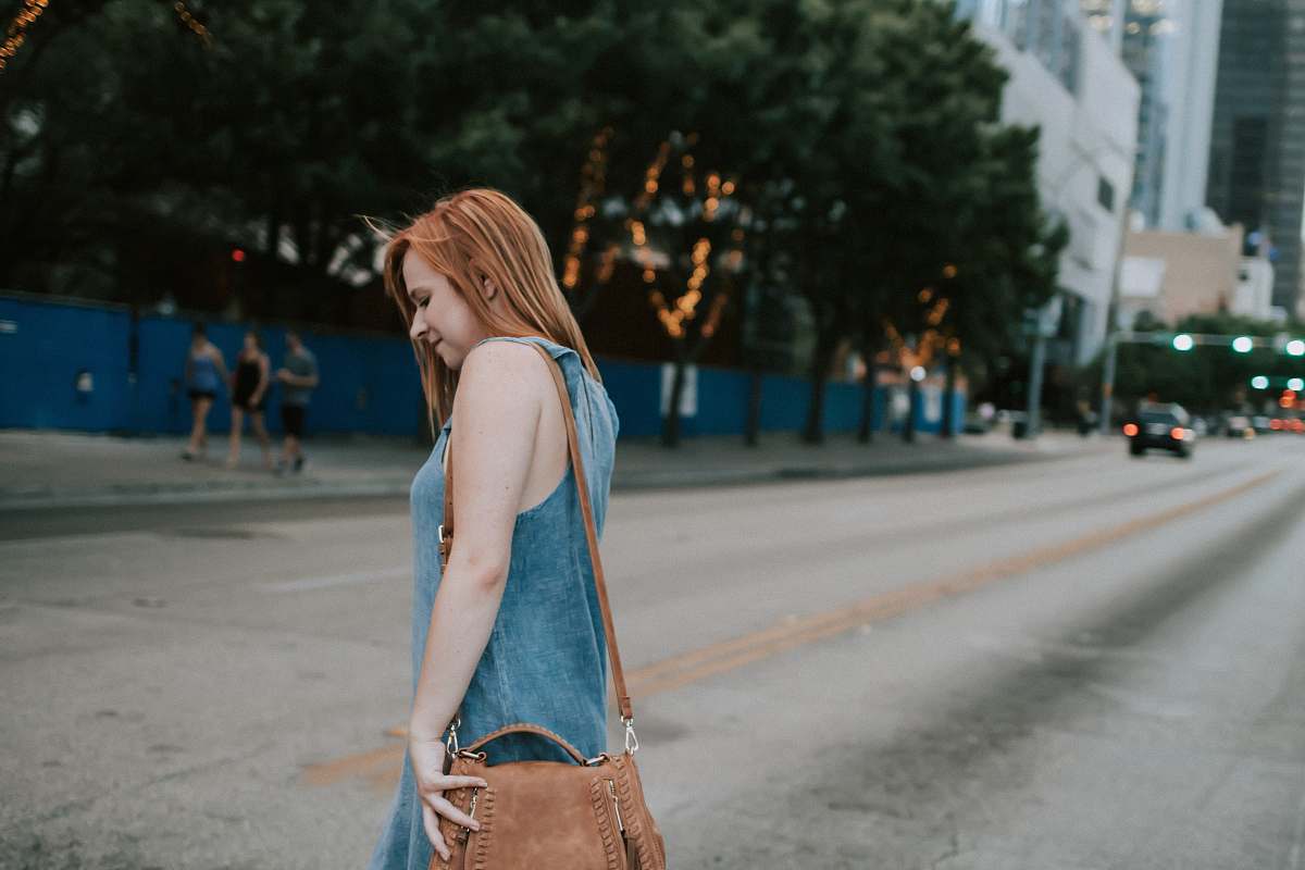 person woman crossing the street during daytime photo people