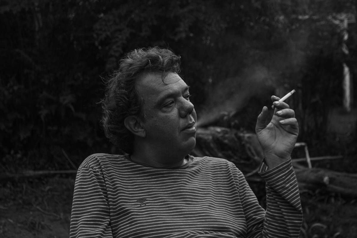 human grayscale photography of man white smoking people
