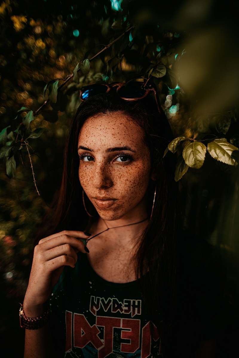 people portrait photography of woman behind leaves person