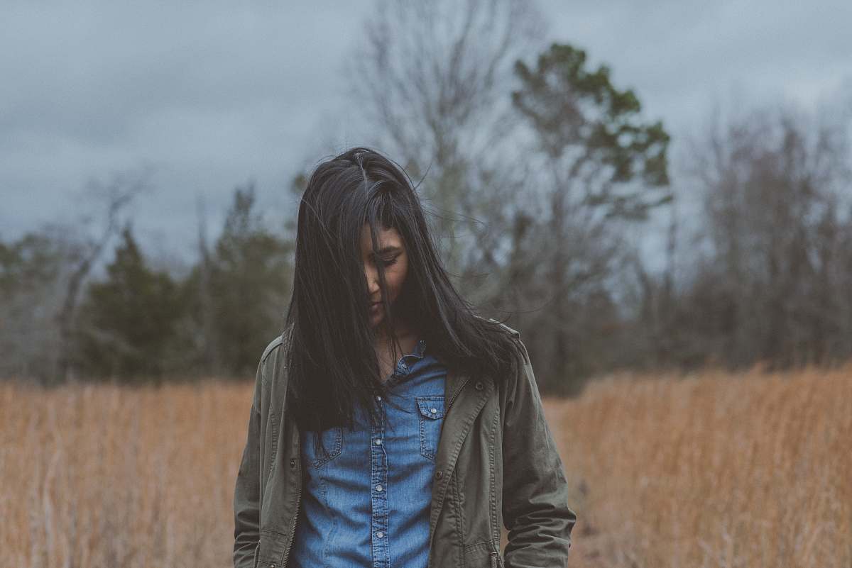 people woman wearing gray cardigan surrounded grass person
