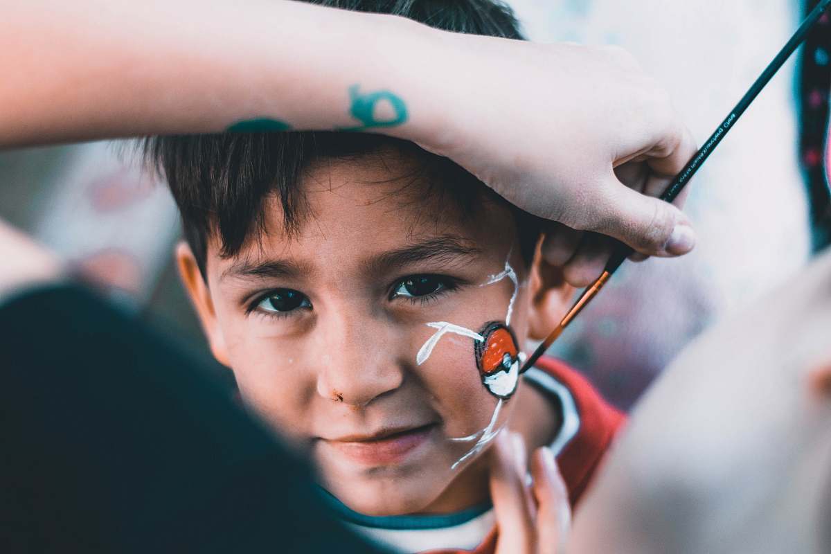 person boy drawn Pokeball on his face human