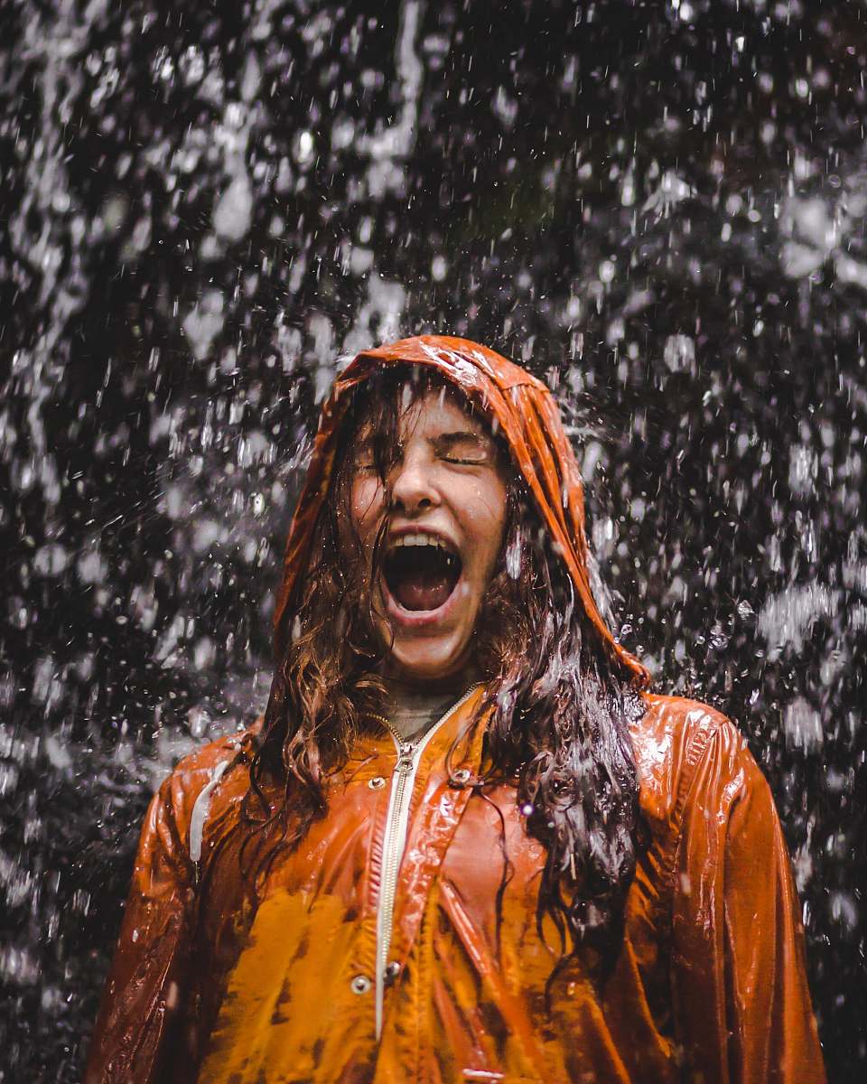 person close-up photo of woman in orange coat human