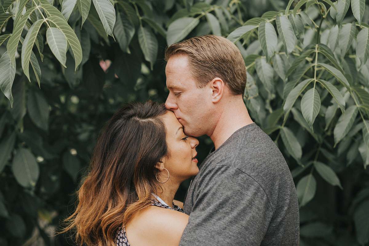 kiss couple hugging near tree leafs kissing