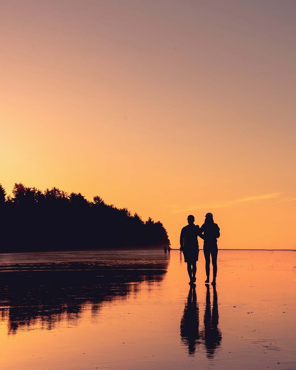 human couple standing on body of water person