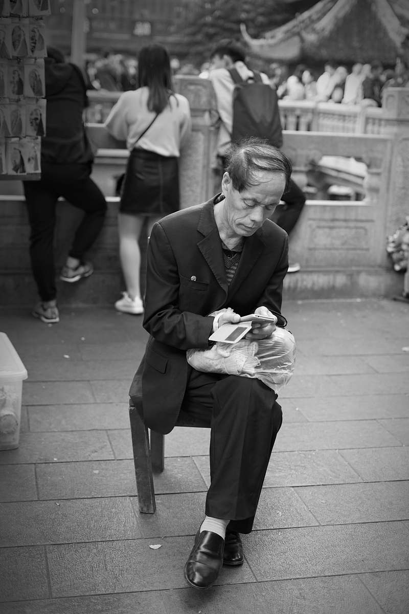 human grayscale man sitting on chair black-and-white