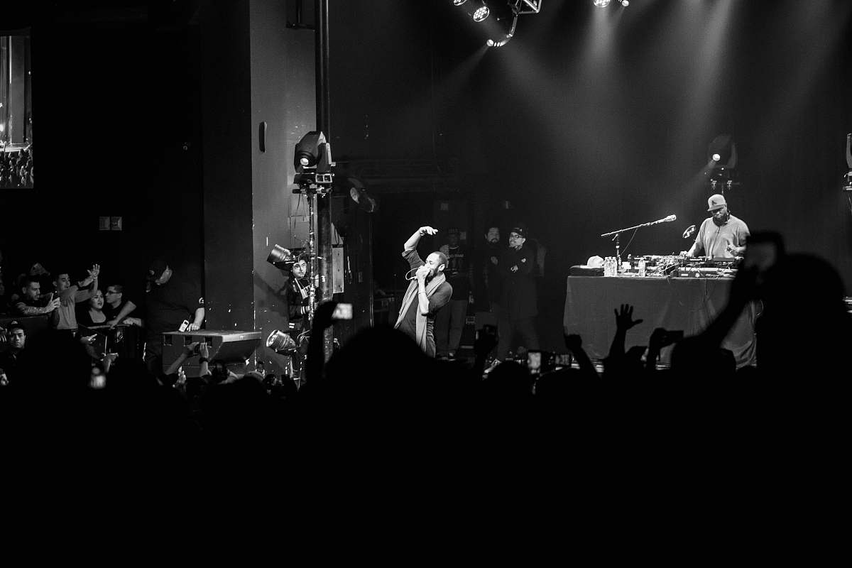 human grayscale photo of a concert on the stage black-and-white